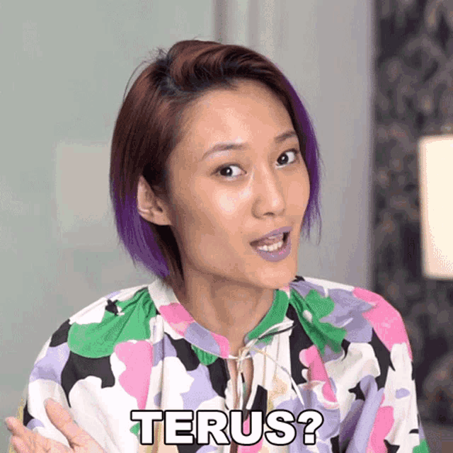 a woman with purple hair is wearing a floral shirt and says terus