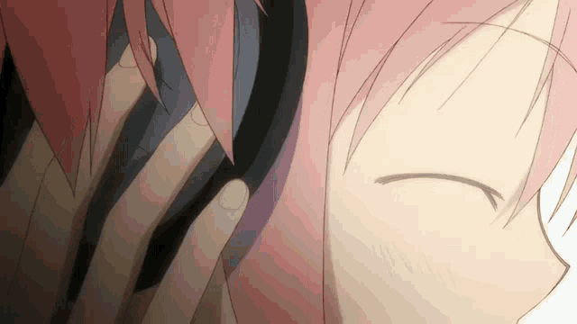 a close up of a person with pink hair