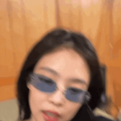 a close up of a woman wearing blue sunglasses .