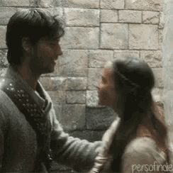 a man and a woman are looking into each other 's eyes .