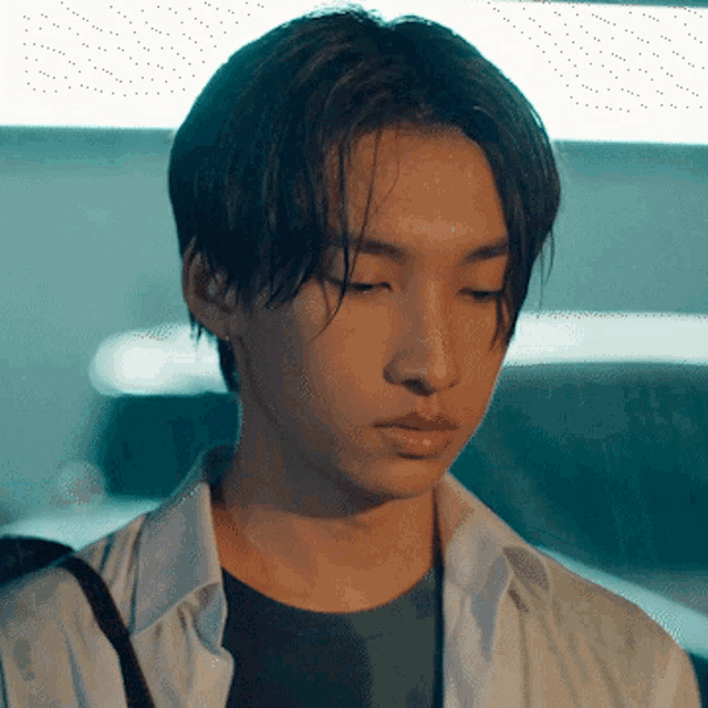 a close up of a young man 's face with a serious look on his face