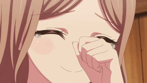a woman is covering her face with her hand and crying
