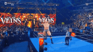a man in a wrestling ring with the words in my veins on the screen