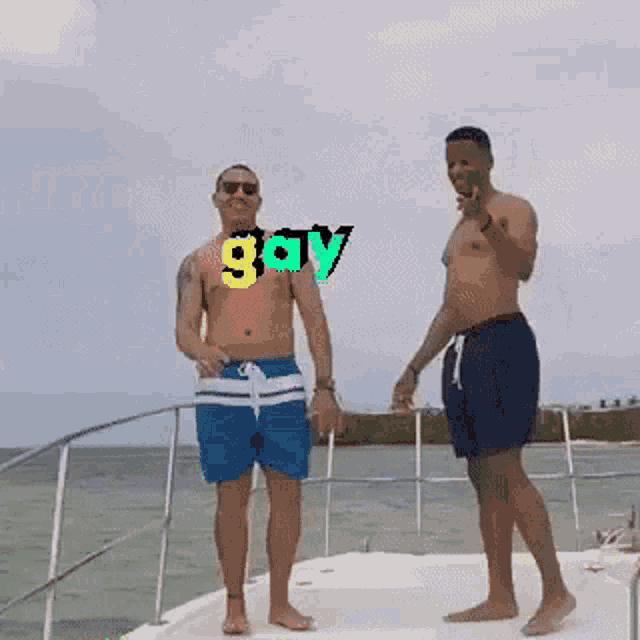 two men standing on a boat with the word gay written on their chests
