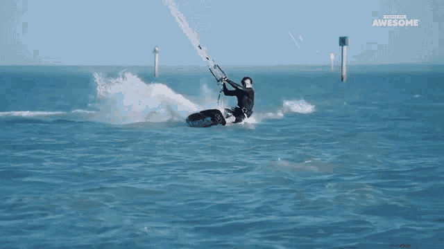 a man is riding a surfboard in the ocean with the words awesome written above him