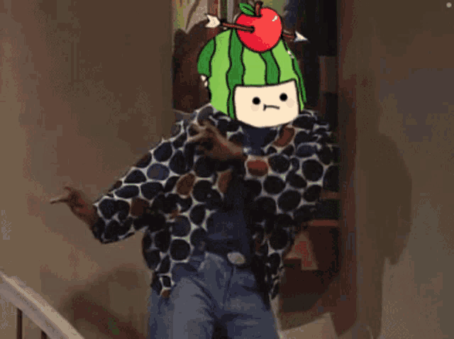 a person wearing a watermelon hat with an apple on top of it