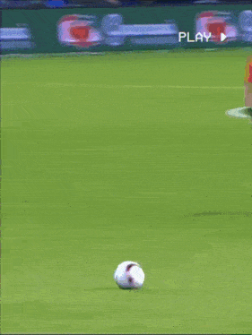 soccer players on a field with a guarana play banner