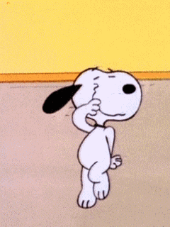 snoopy is dancing in a room with a yellow wall in the background