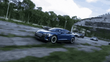 a blue car is driving down a dirt road in a video game