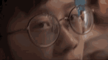 a close up of a person wearing glasses