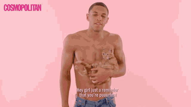a shirtless man is holding a cat in front of a pink background that says cosmopolitan