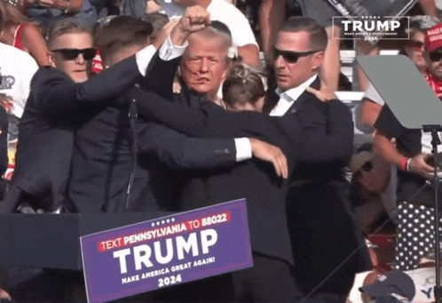 a man holding a sign that says trump 2024