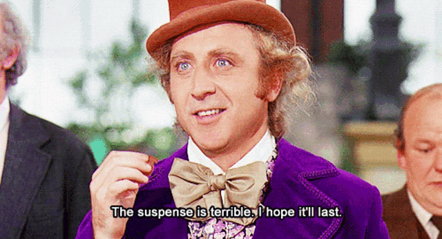 a man wearing a top hat and a purple suit says the suspense is terrible i hope it 'll last