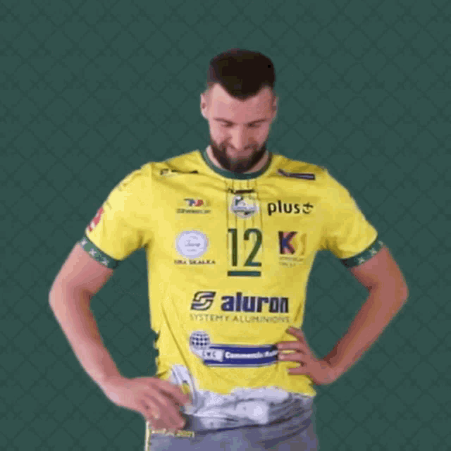 a man in a yellow shirt with the number 12 on the front