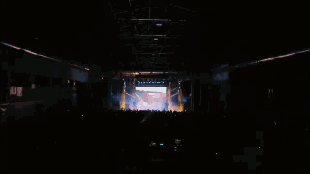 a blurry image of a man standing in front of a green light