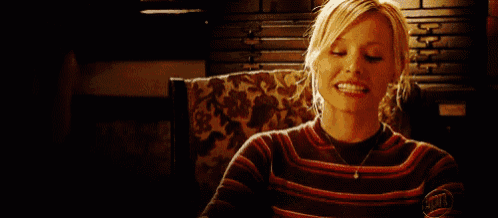 a woman sitting in a chair with a sweater that says ' abercrombie & fitch '