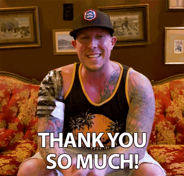 a man with a prosthetic arm is sitting on a couch and saying thank you so much
