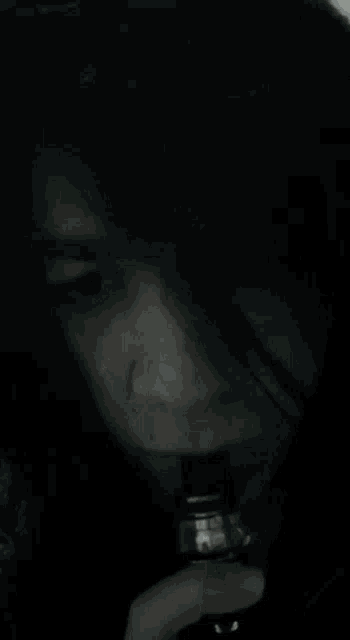 a blurry picture of a person smoking a cigarette