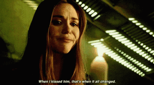 a woman is crying in front of a lit candle and a candle .