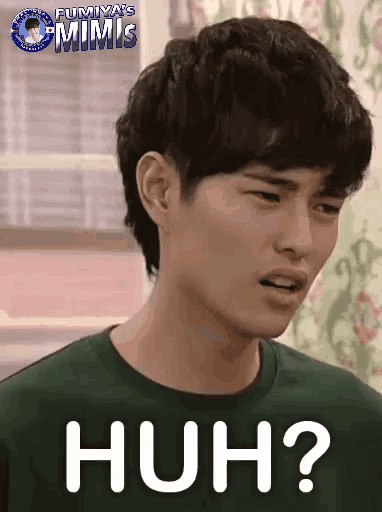 a man with a green shirt has the word huh on his chest