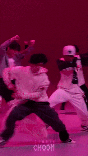 a group of people are dancing in front of a pink background that says choom