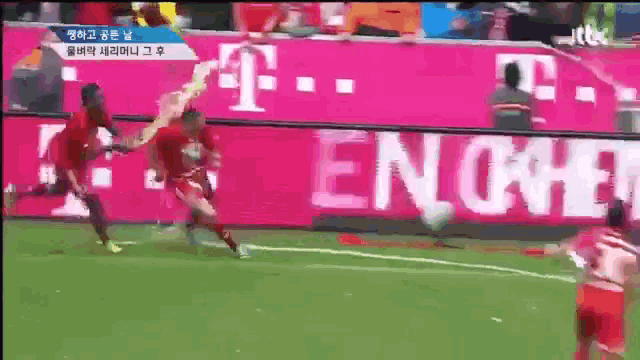 a soccer game is being played in front of a t-mobile banner