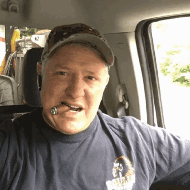 a man with a cigar in his mouth is wearing a t-shirt that says ' freedom ' on it