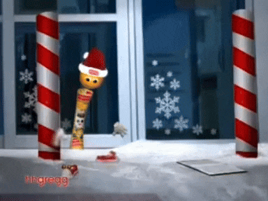 a candy cane stick wearing a santa hat is standing in front of a window