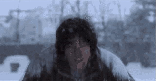 a person is standing in the snow with their face covered in snow