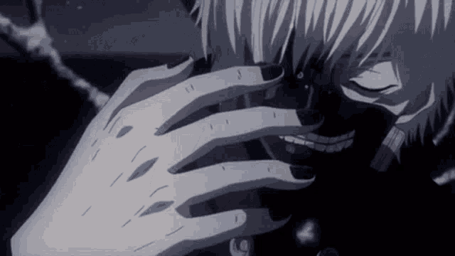 a close up of a person 's hand covering their face .