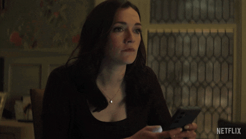 a woman says " you shouldn 't have netflix " in front of a window