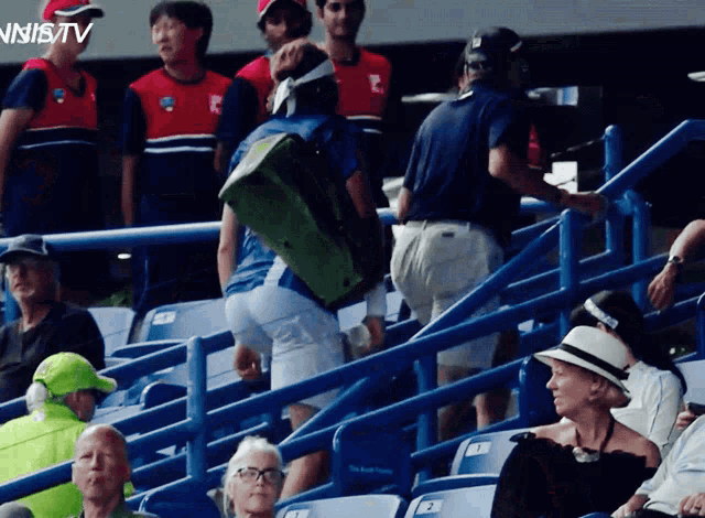 a group of people sitting in a stadium with the words tennis tv on the bottom right
