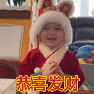 a little girl wearing a santa hat and a red jacket with chinese writing on it