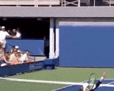 a tennis player is swinging a racket on a blue court with a sign that says ihg in the background