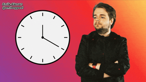 a man with his arms crossed stands in front of a clock with emilio aleman written on the bottom right