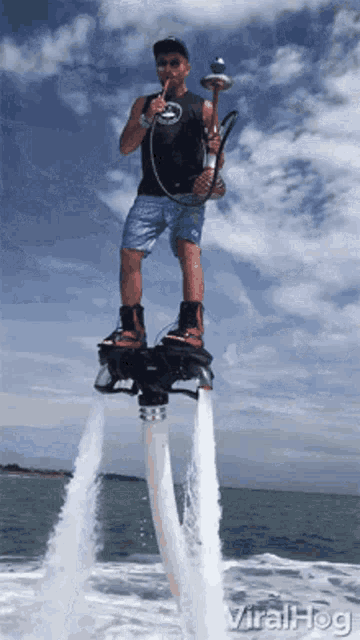 a man is flying through the air on a water jet board