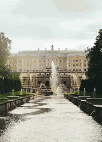 a fountain in front of a large building with a lot of windows