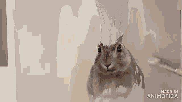a rabbit is being painted on a piece of paper with the words made in animotica on the bottom