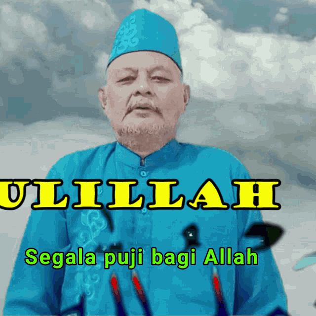 a man in a blue shirt with the words ulilah segala puji bagi allah