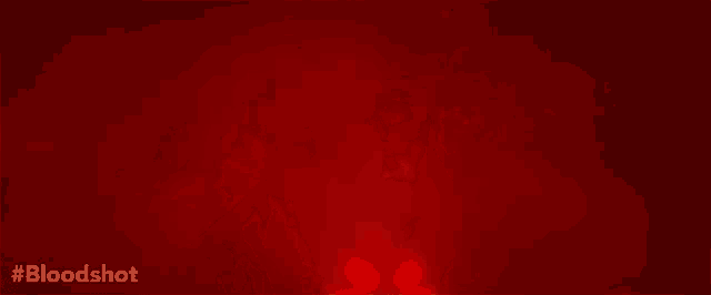 a man in a bloody shirt is standing in front of a red background that says bloodshot