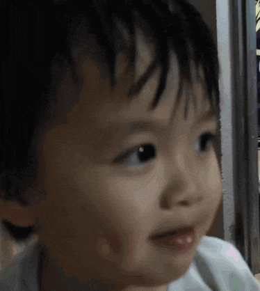 a close up of a baby 's face looking at the camera