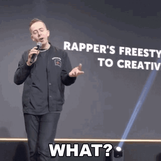 a man stands in front of a sign that says apper 's freesty to creativ