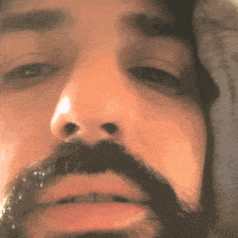 a close up of a man 's face with a mustache