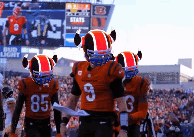 a group of football players wearing horned helmets and jerseys with the number 85 on them