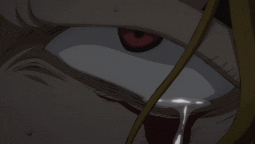 a close up of a person 's eye with blood running down it