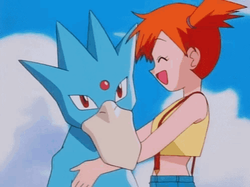 a girl is hugging a blue pokemon .