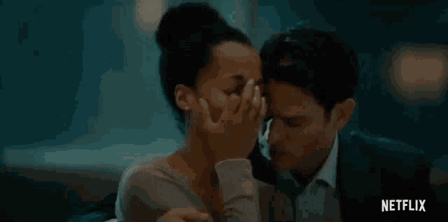 a man and a woman are sitting next to each other and the woman is crying .