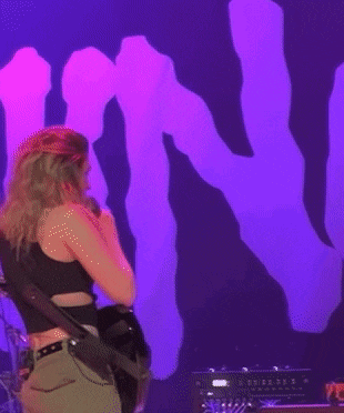 a woman singing into a microphone with the words do you want
