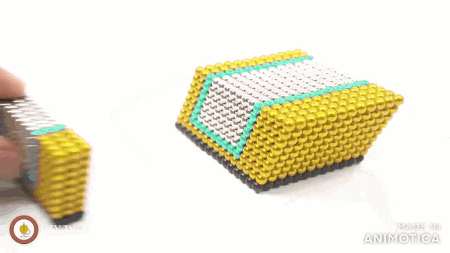 a person is playing with a toy made of magnets that says made in animatica on the bottom