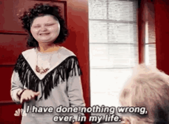 a woman is standing in front of a window and saying i have done nothing wrong ever in my life .